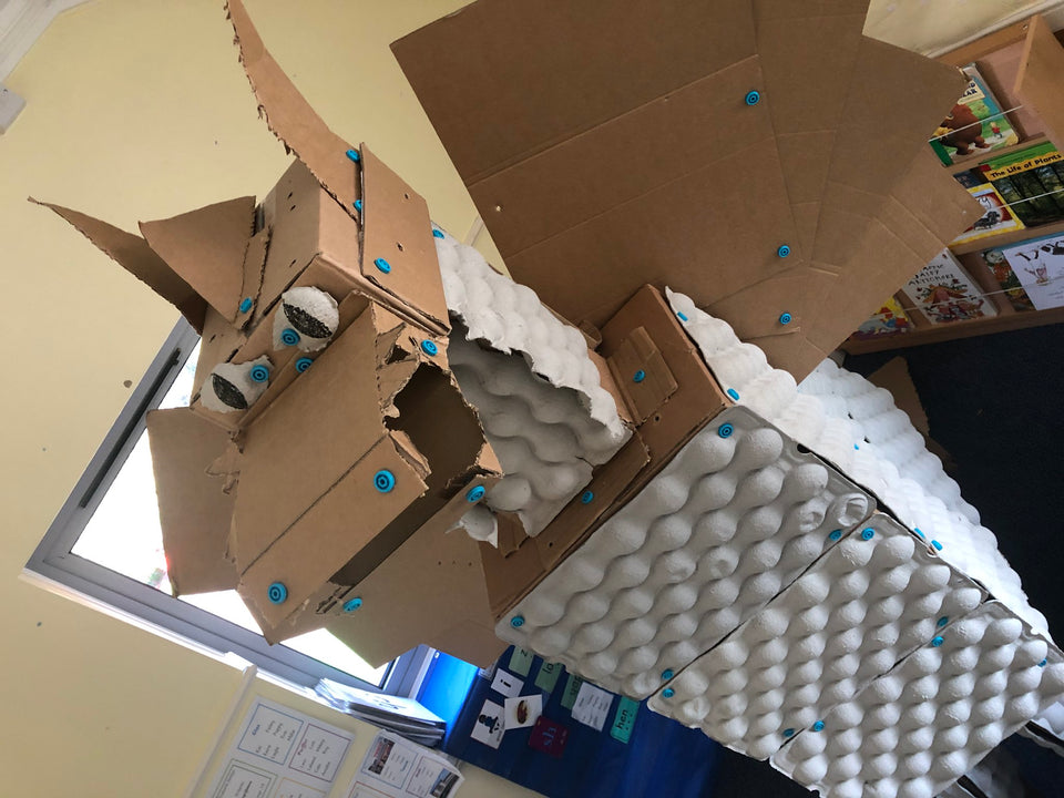 Giant cardboard dragon built with cardboard egg crates and Makedo construction system