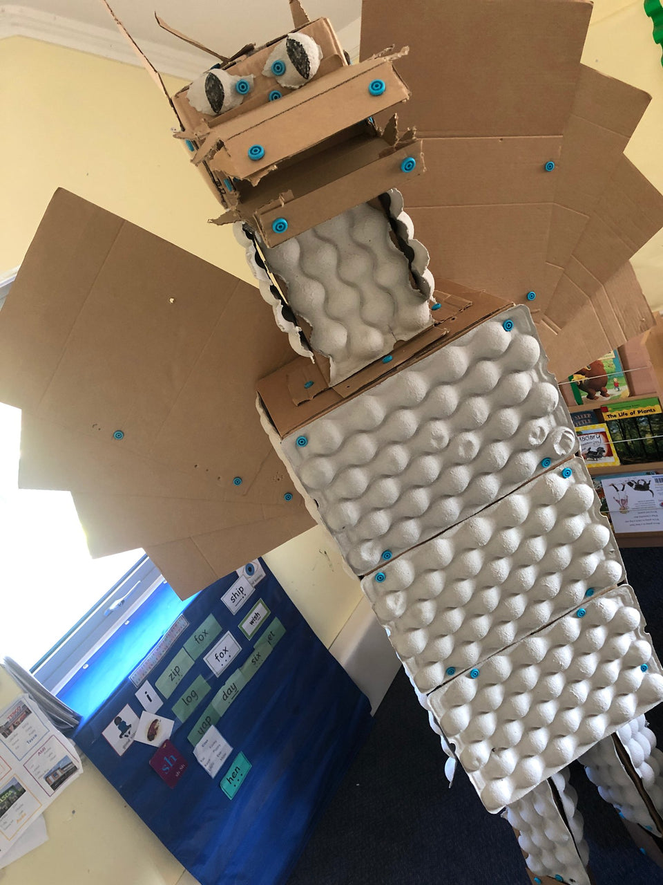 Giant cardboard dragon built with cardboard egg crates and Makedo construction system