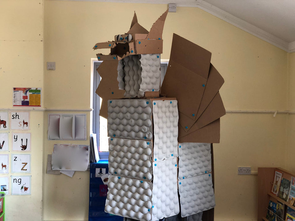 Giant cardboard dragon built with cardboard egg crates and Makedo