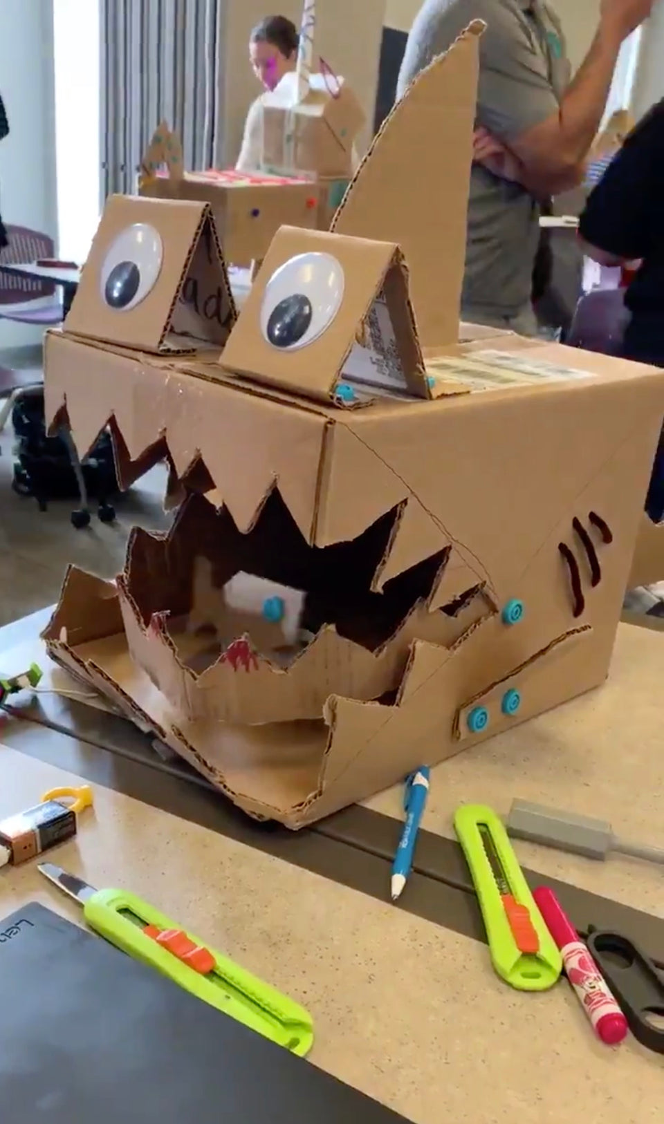 Makedo cardboard shark with littlebits animated fish inside its mouth.
