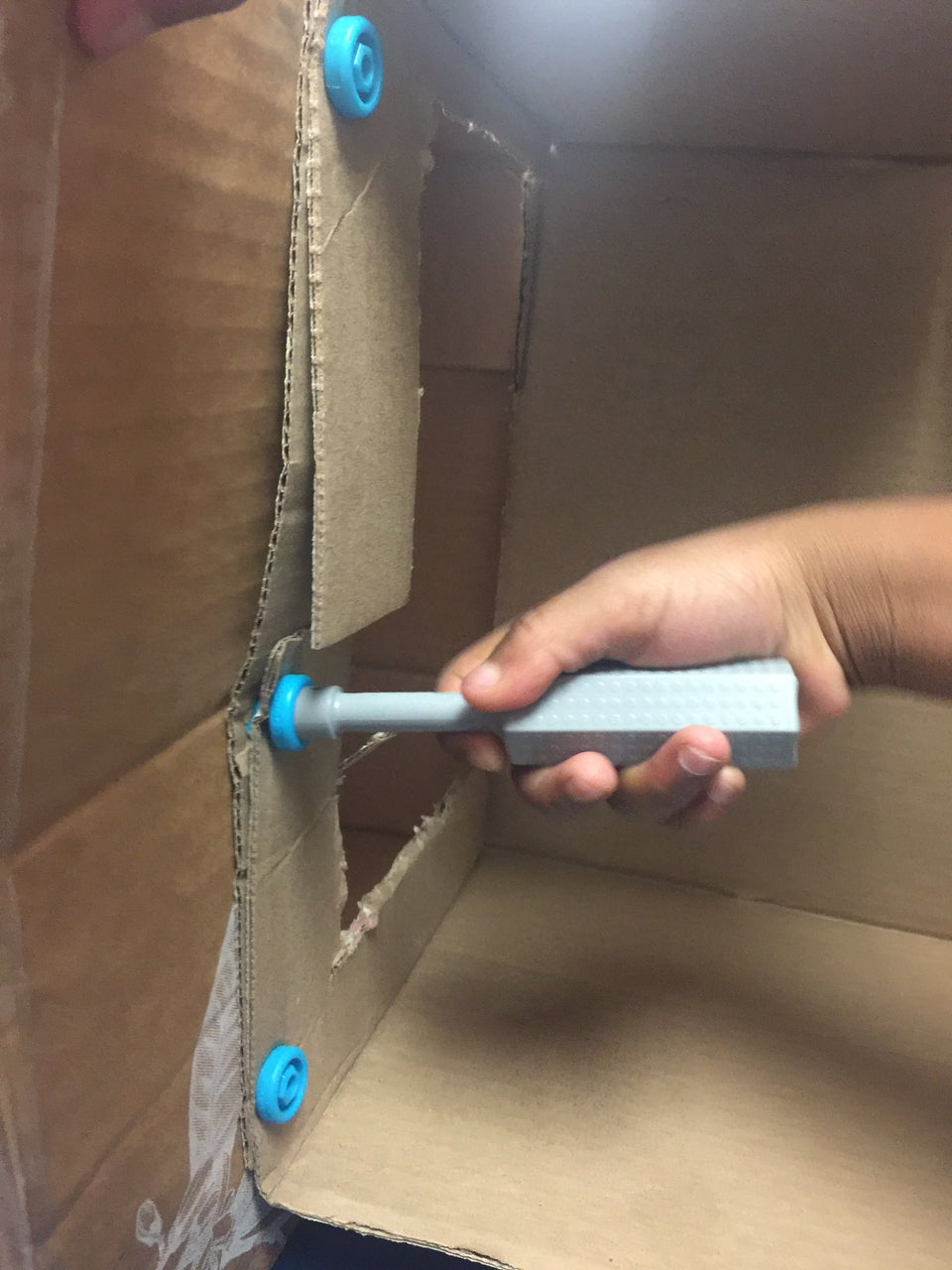 Makedo Scrudriver in action connecting cardboard easily.