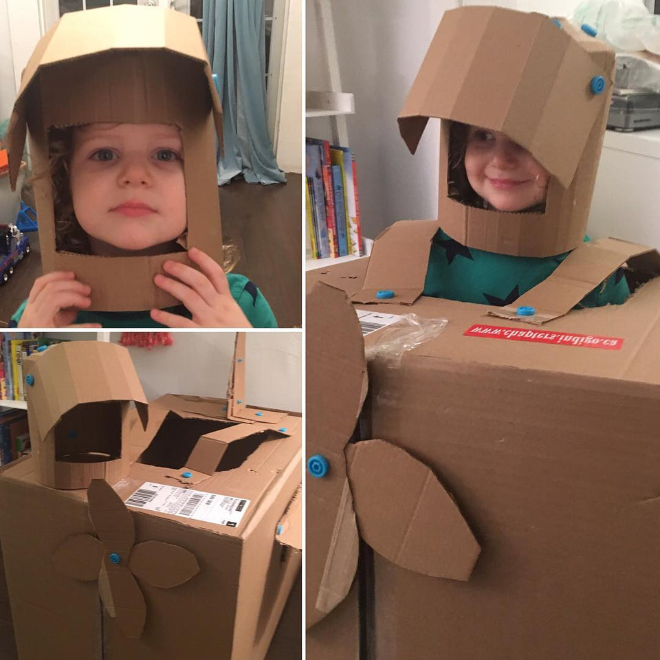 Wearable airplane costume using Makedo cardboard construction tools.